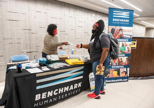Photo of a company representative talking to a student.