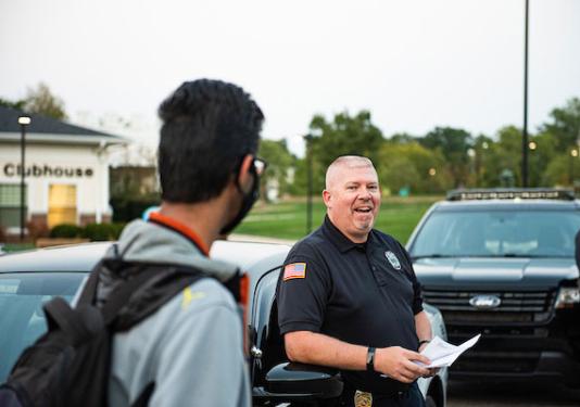 A University Police officer chats with a student