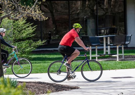 Two bicyclists on the Purdue Fort Wayne Campus