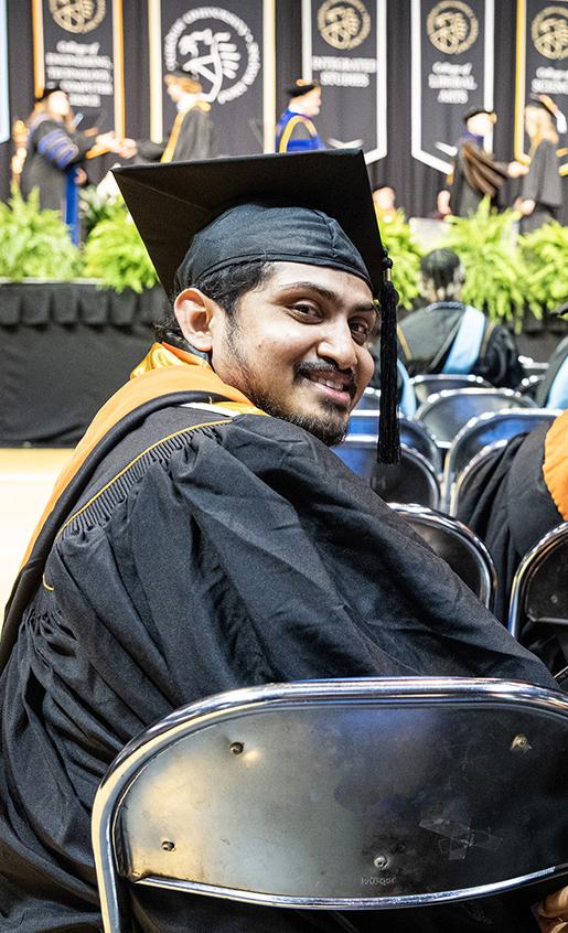 Two graduate looking behind them