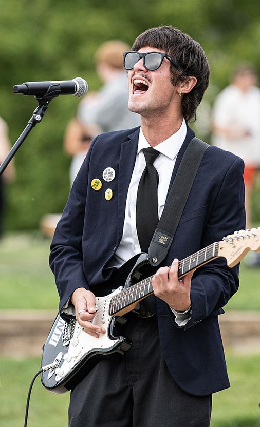 Noah Sties is singing and playing a guitar