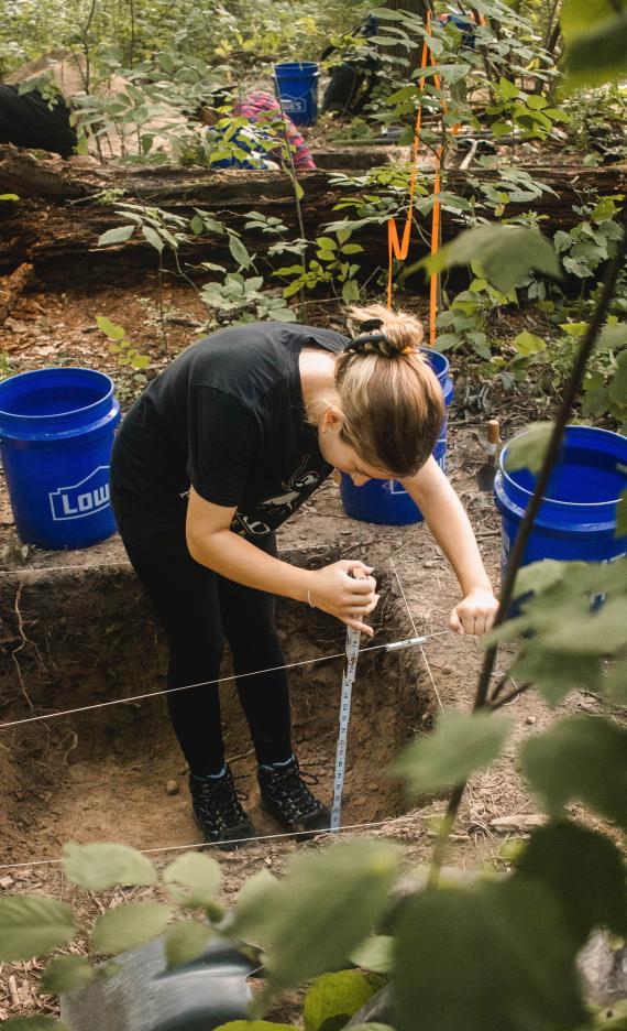 Student excavating dig site during Field School