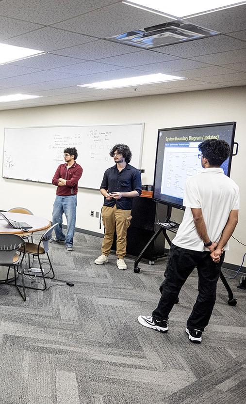 Members of the Lunabotics team and faculty are in a classroom