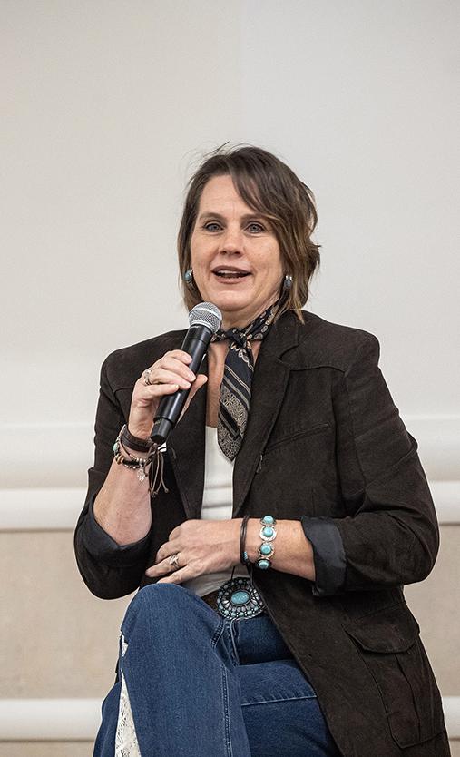 A women is speaking into a microphone