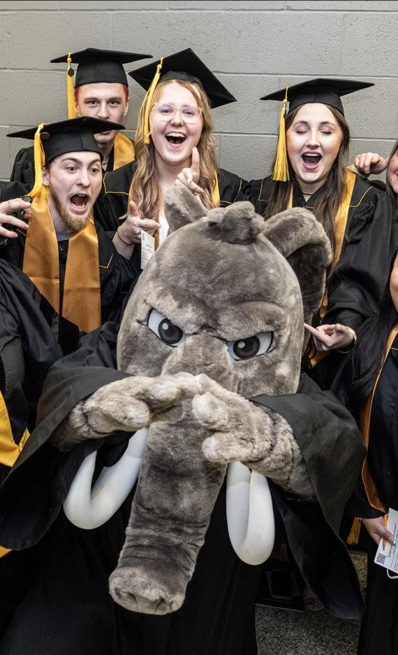 Don poses with students during the 2026 PFW commencement ceremony