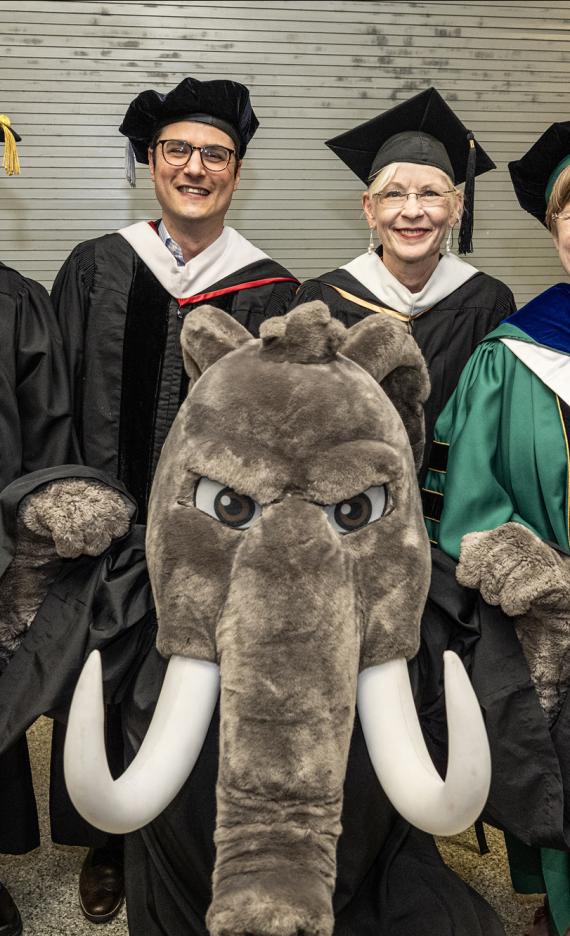 Don posses with factulty at the 2026 PFW commencement ceremony