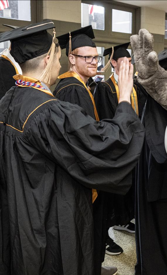 Don gives out high fives at the 2026 PFW commencement ceremony