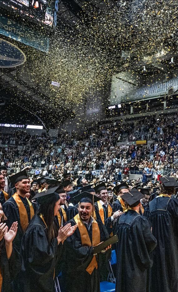 Students celebrate with confetti at the end of the 2026 commencement ceremony