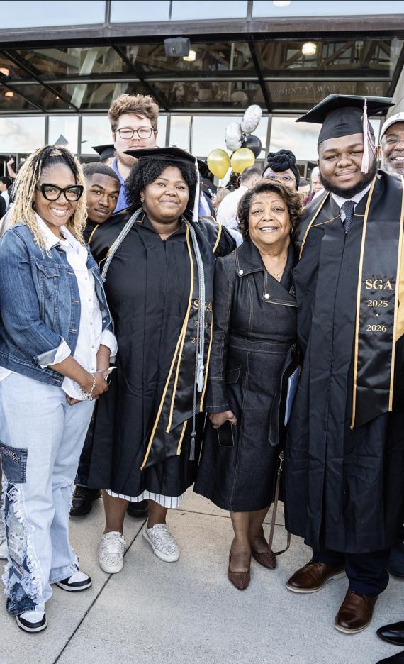 A family poses outside the 2026 commencement ceremony