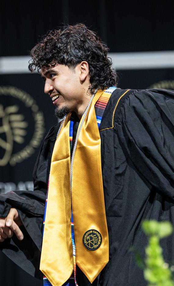 The Chancellor and a student shake hands at the 2026 commencement ceremony