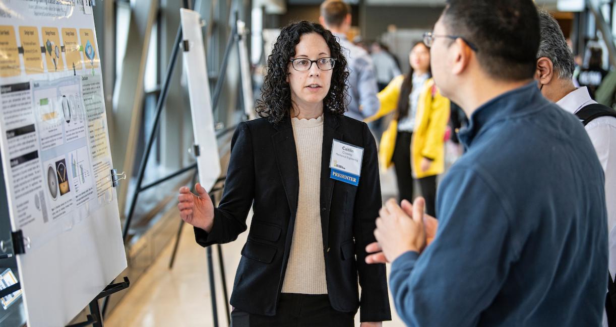 A mechanical engineering student presents a project during the Creative Symposium.