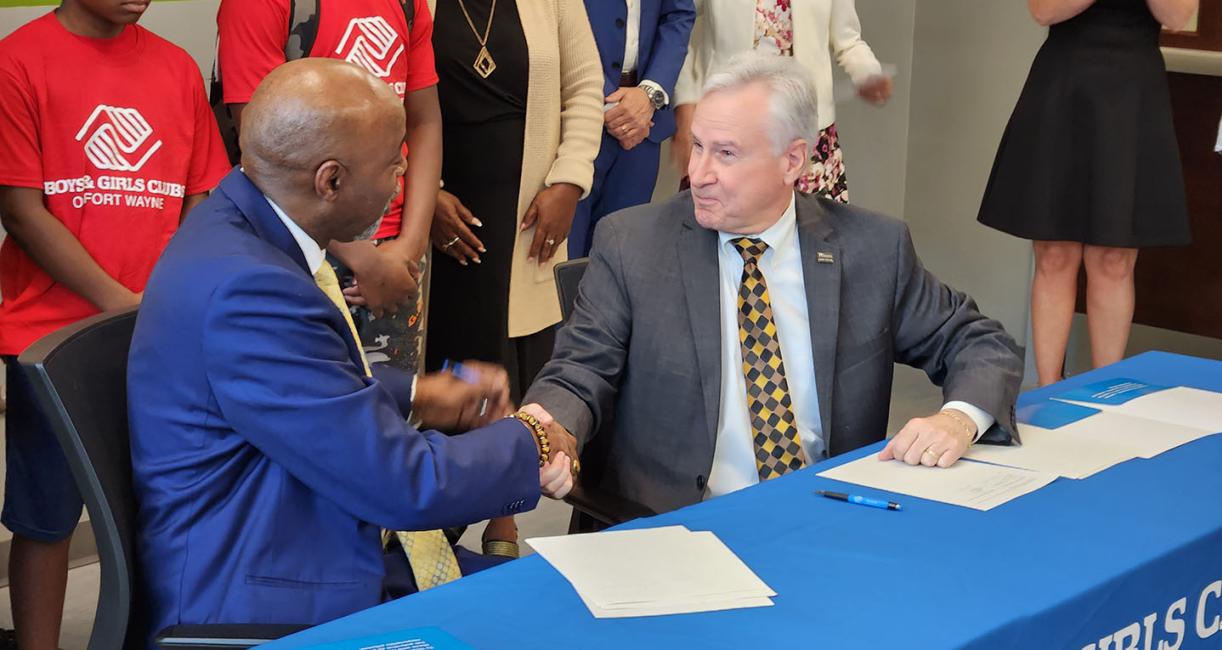 Joe Jordan and Ron Chancellor shake hands after signing the memorandum of understanding.