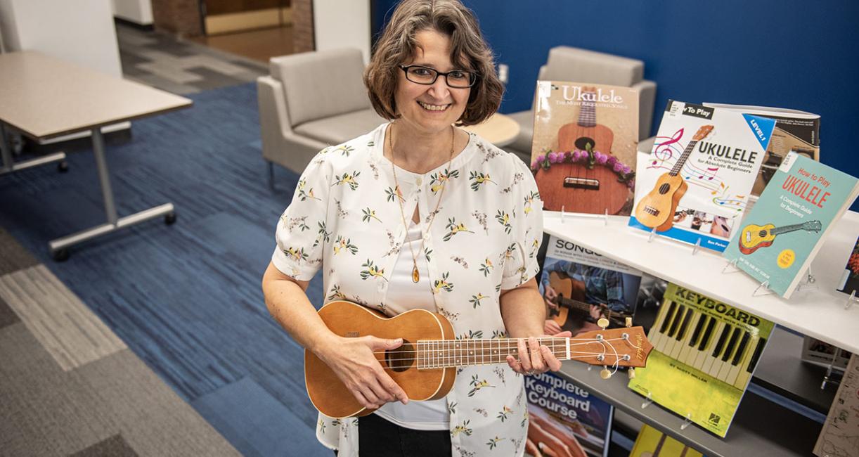 A person is holding a ukulele.