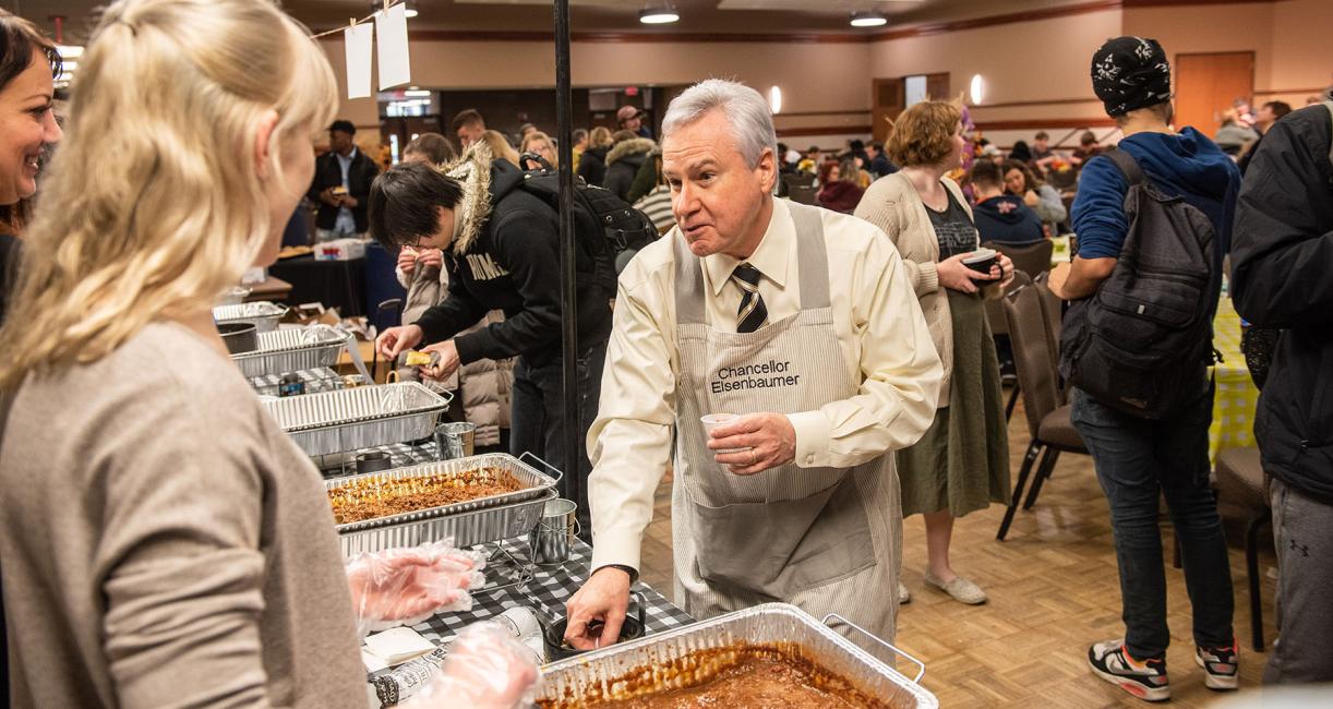 Chancellor Ron Elsenbaumer serves chili at a previous Chili Fest.