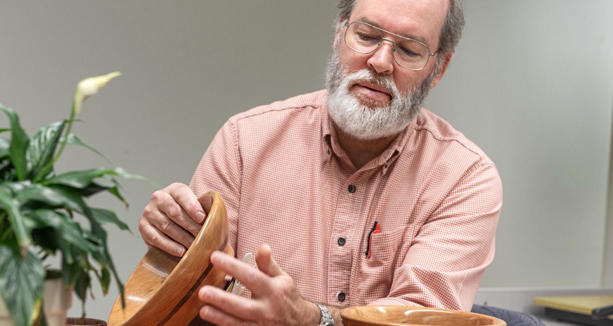 Barry Dupen displays some of the bowls he created.