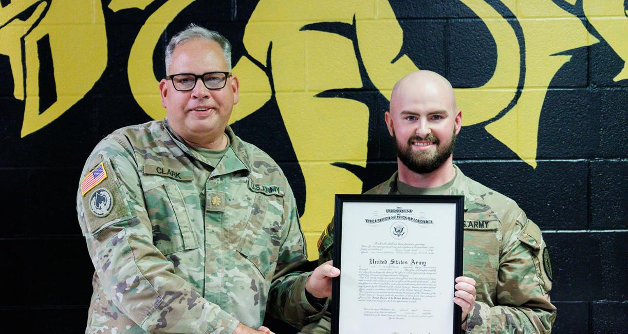 Tom Bond receives the rank of Lieutenant from Major David Clark, assistant professor of military science and the U.S. Army Officer responsible for the PFW program.