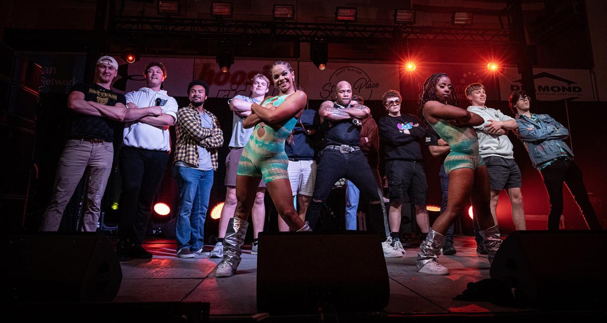 Flo Rida and dancers pose on stage with a group of Purdue University Fort Wayne students