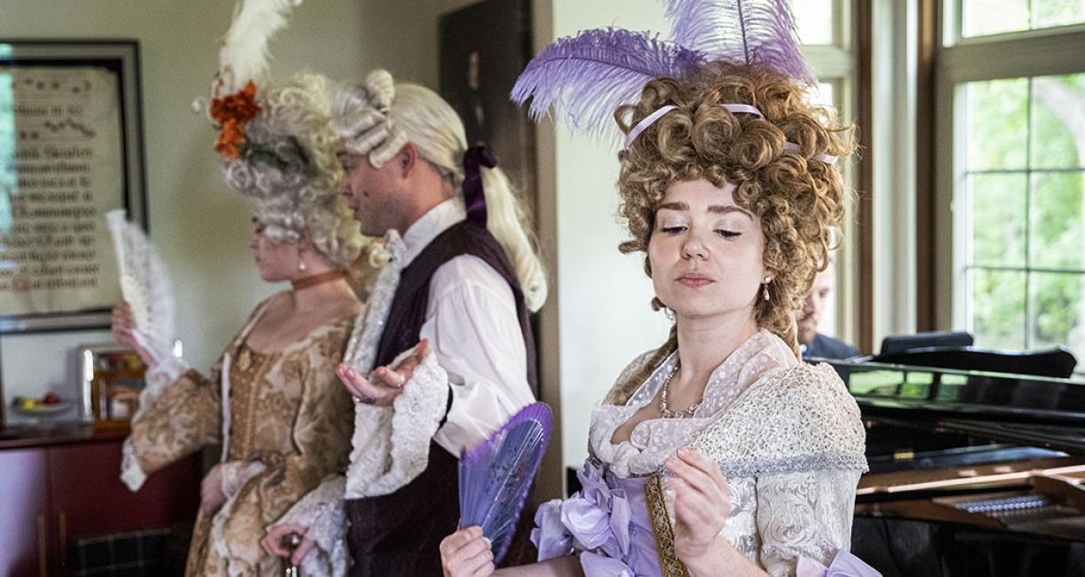 Katherine Marx in costume singing during a music fundraising event