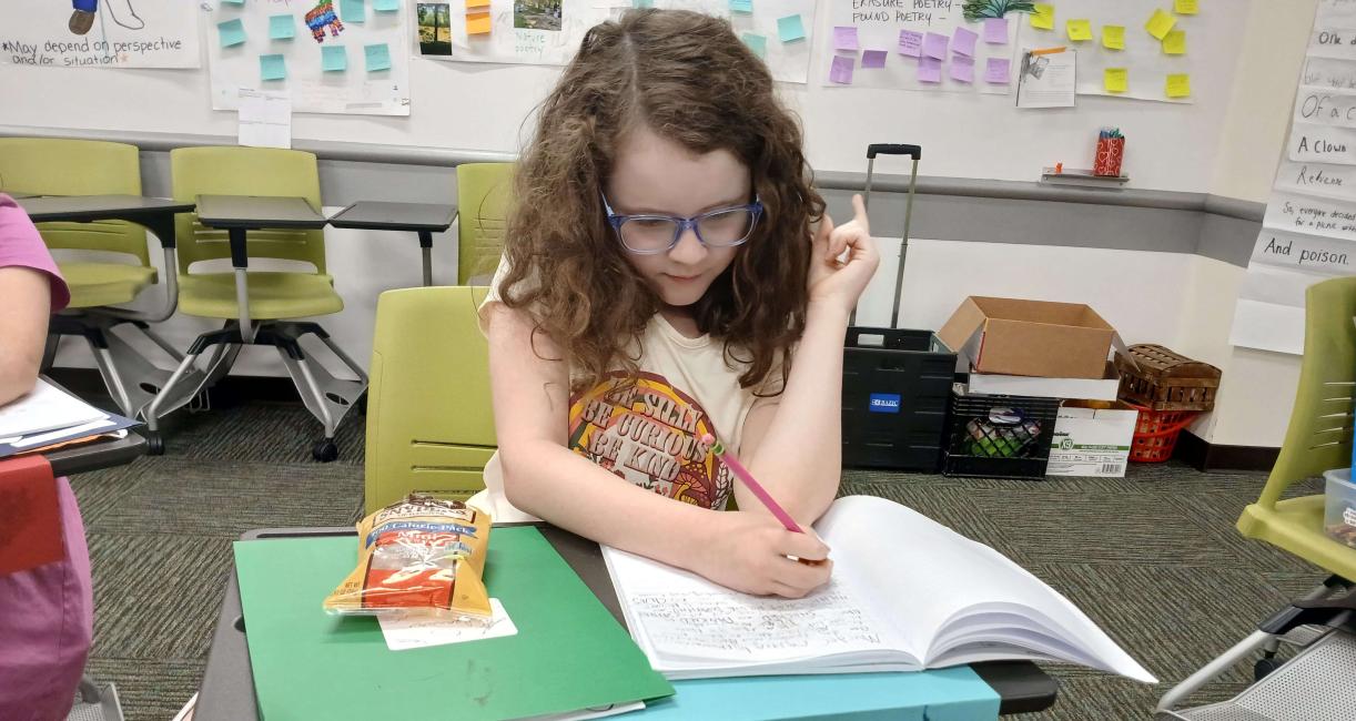 Peace Montessori 4th grader Eleanor Mowan puts the finishing touches on a story she's been writing as part of the Appleseed Writing Project summer camp at PFW.