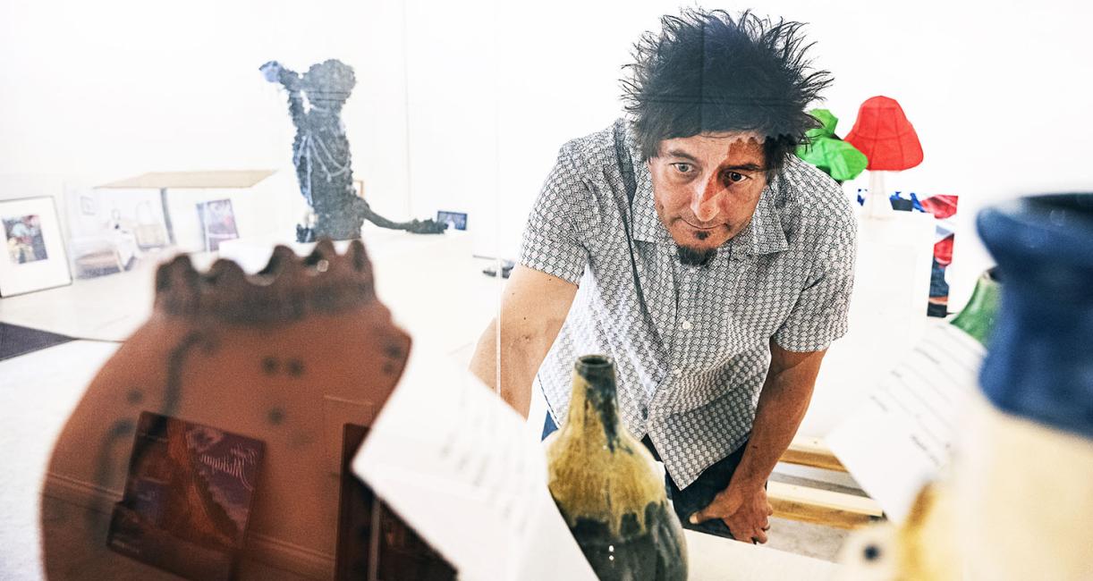 Derek Decker working in an art gallery