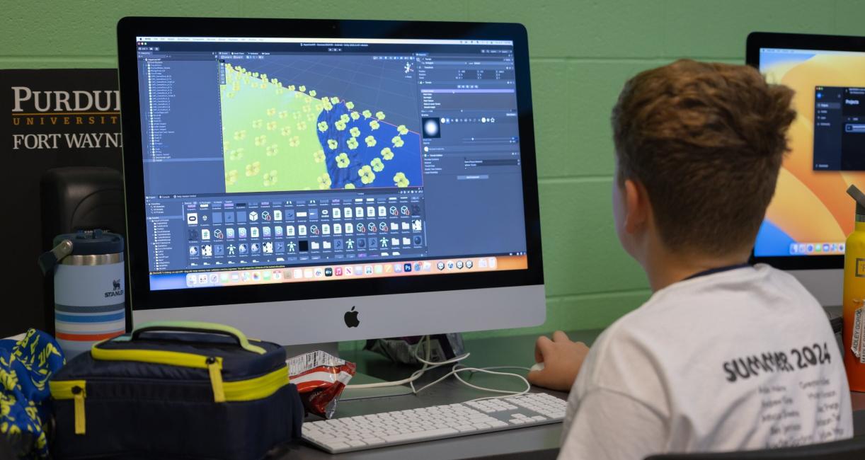 A student is working on a computer at VR camp