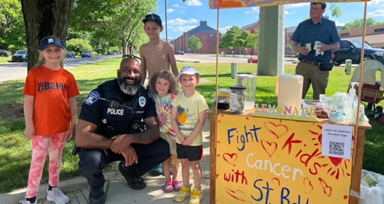 Chief Harrison with children at a cancer fundraiser.
