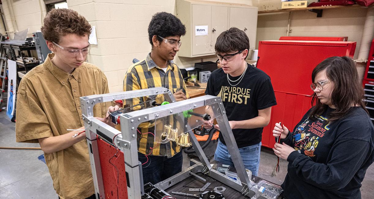 Drew Clem is working with robotics team students