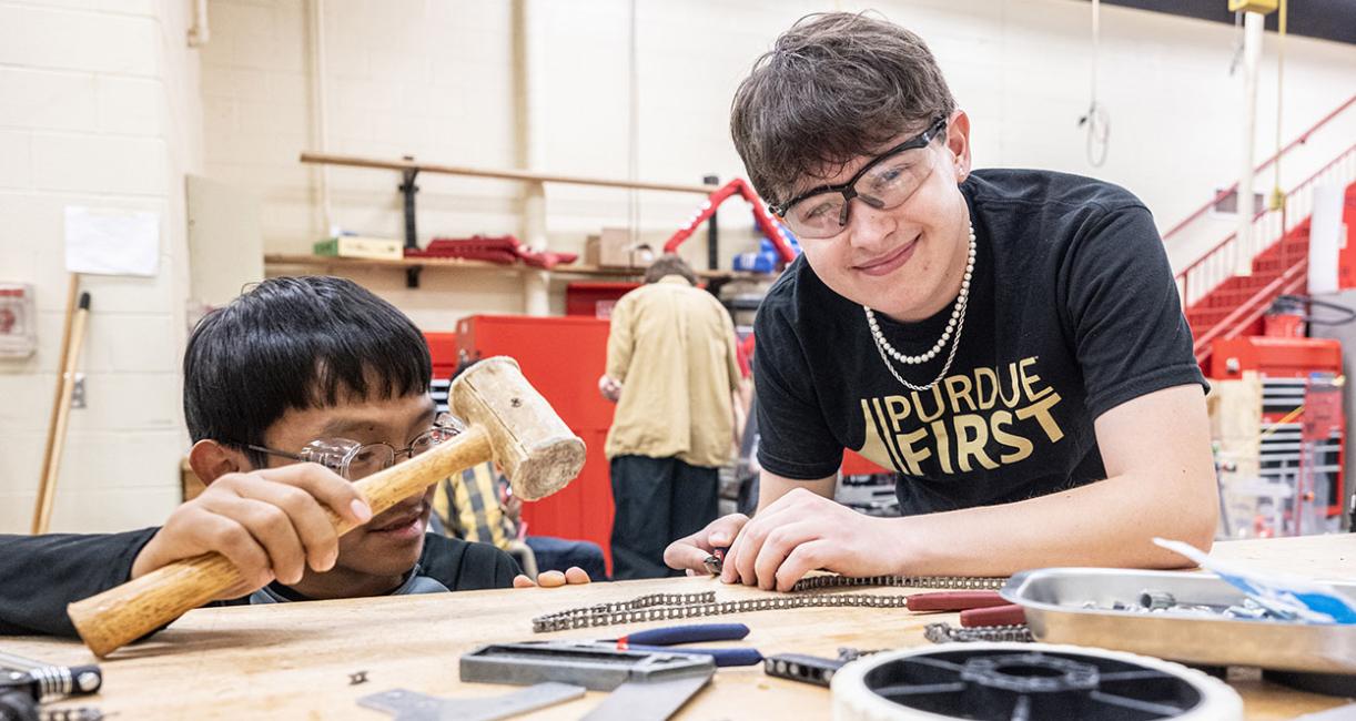 Drew Clem is working with robotics team students