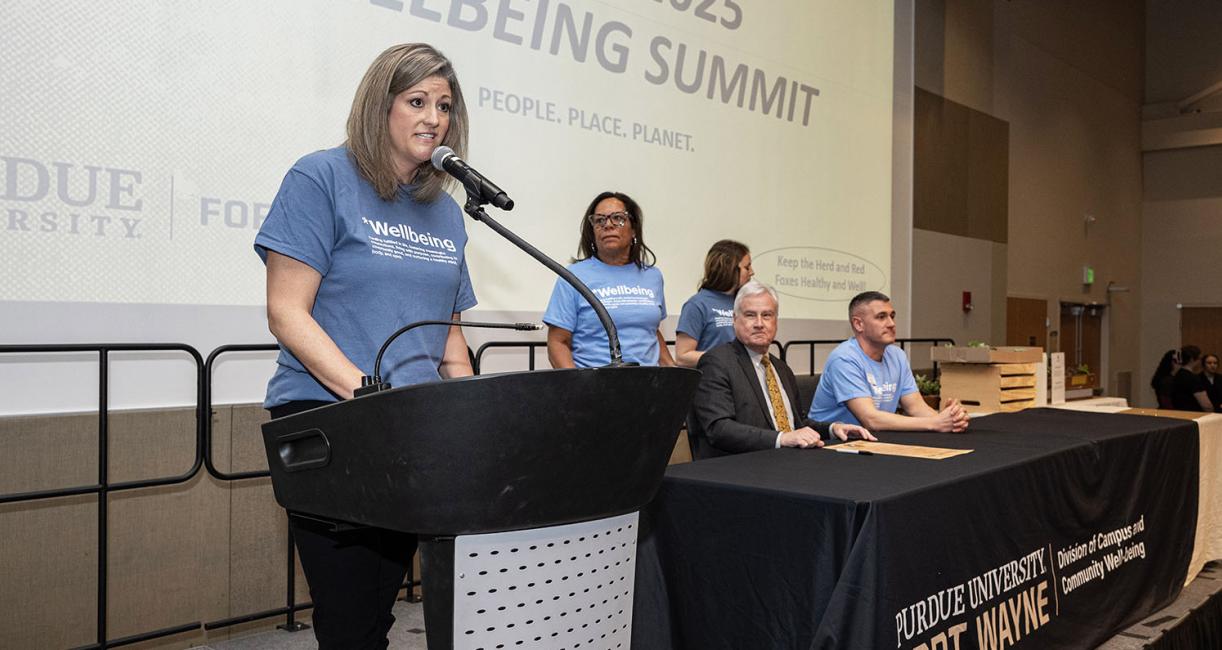 Kerrie Finneran, chief of campus and community wellbeing, addressed attendees of the Wellbeing Summit before the charter signing ceremony.