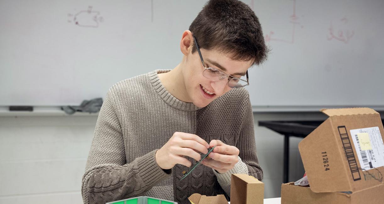 An engineering student is working on a satellite component