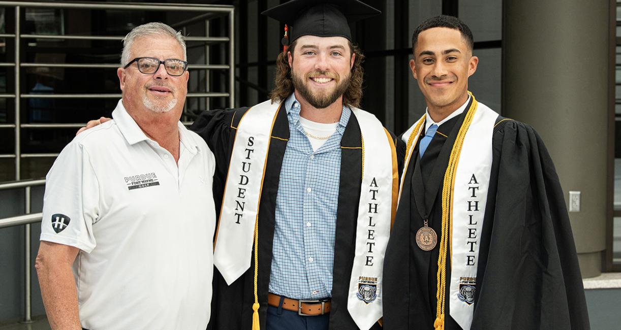 Two student athletes and their coach
