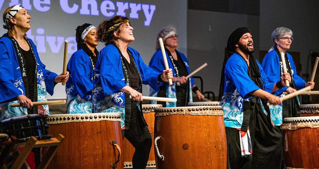 Taiko drummers are performing at the Cherry Blossom Festival