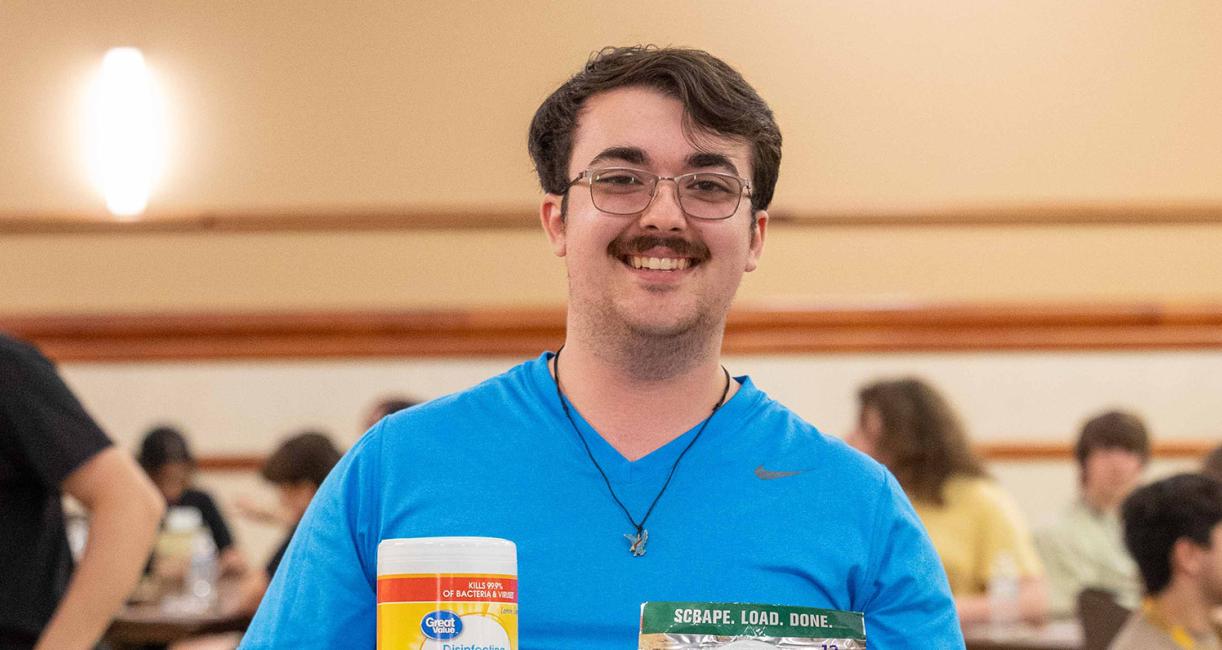 A new student is displaying his bingo prizes at NSO bingo night