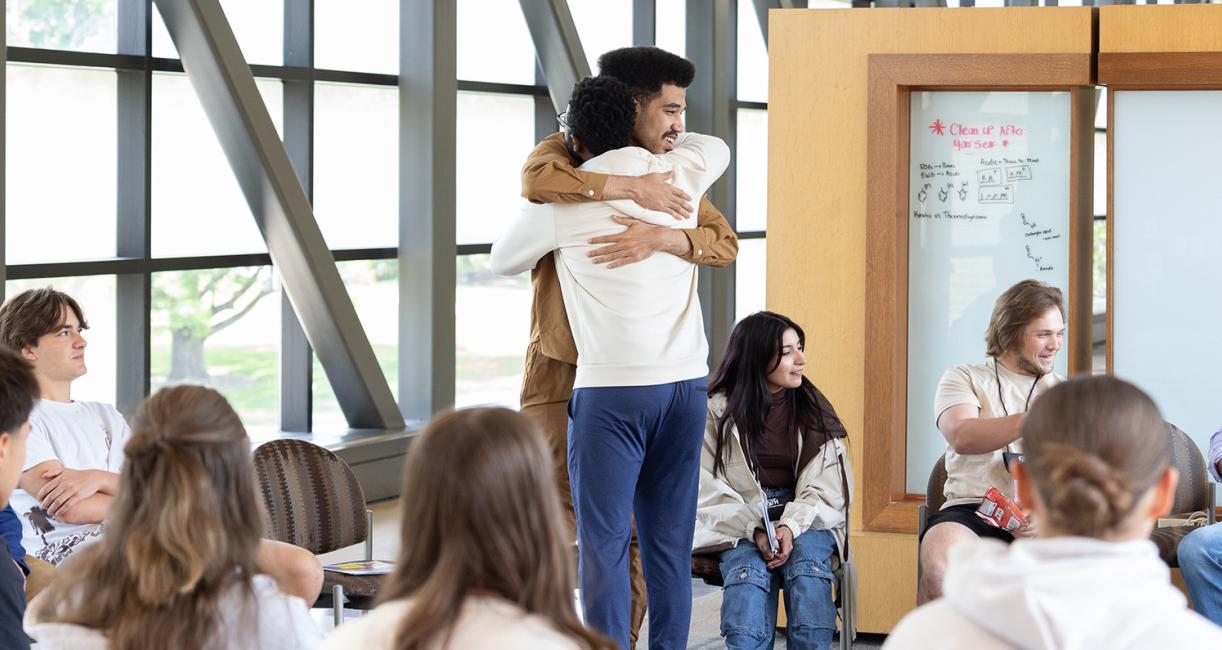 Two students are hugging at the Pave the Path conference