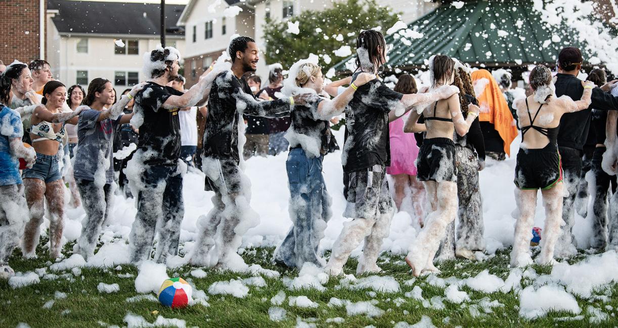 Students line dancing at the Foam Party at the Disco