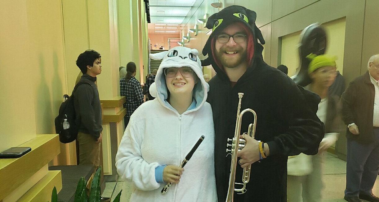 Two orchestra members are wearing Halloween costumes