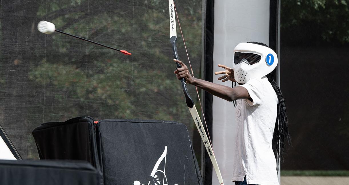 Student with a bow and arrow at RecFest