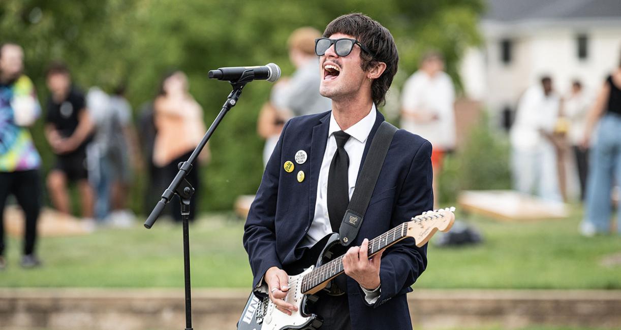 Noah Sties is singing and playing a guitar