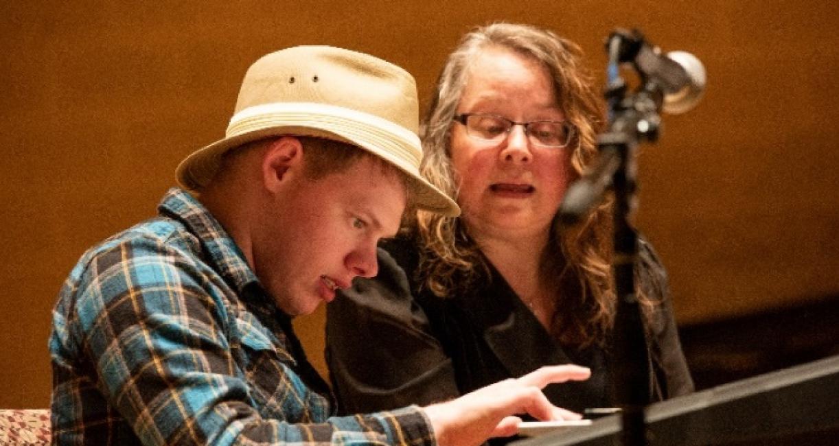 A music therapist is performing with a client