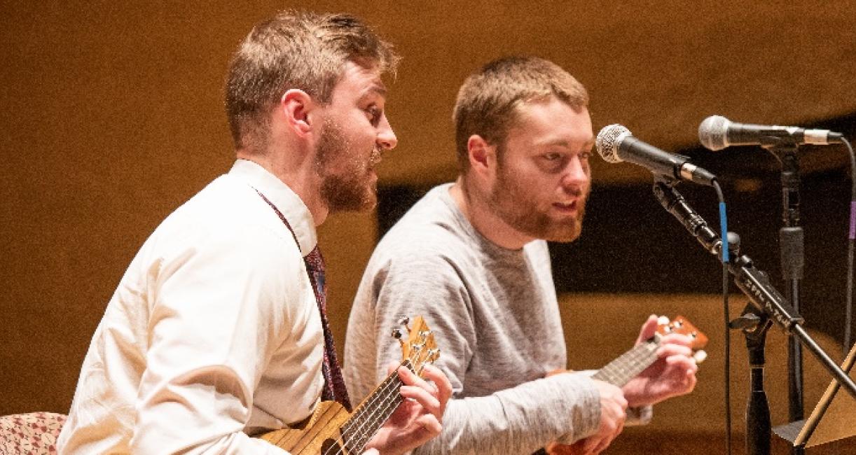 A music therapist is performing with a client