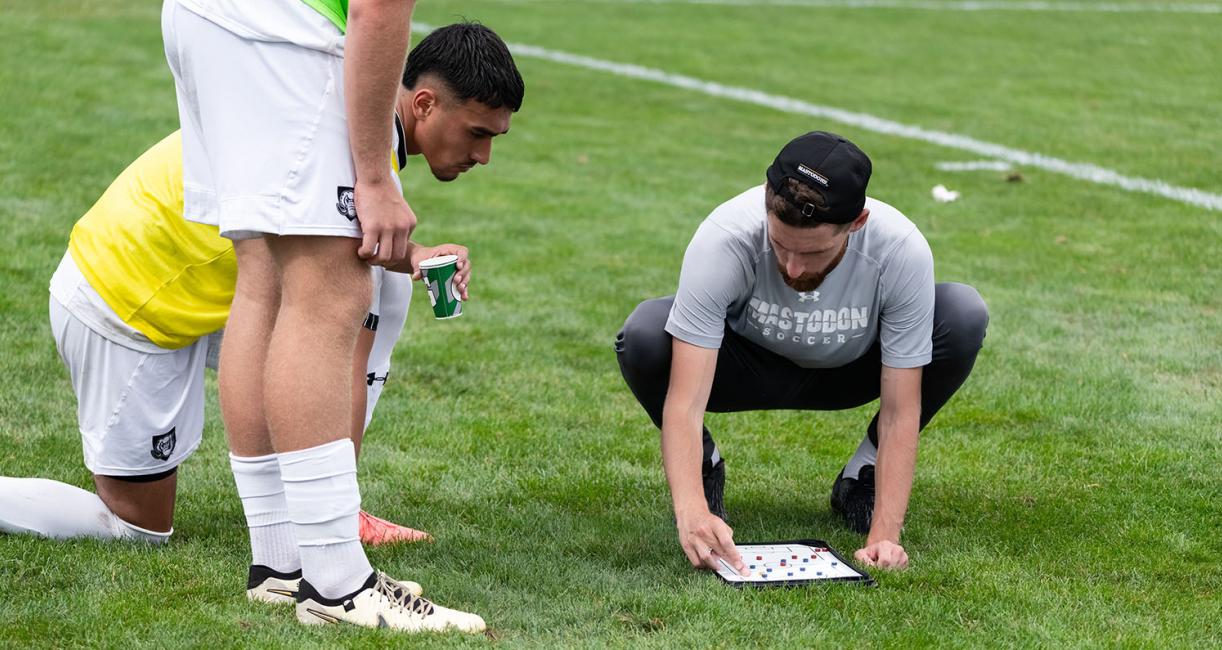 A coach is working with a student-athlete