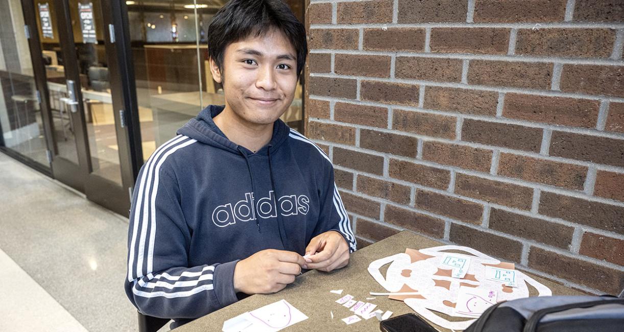 A student is working on a craft