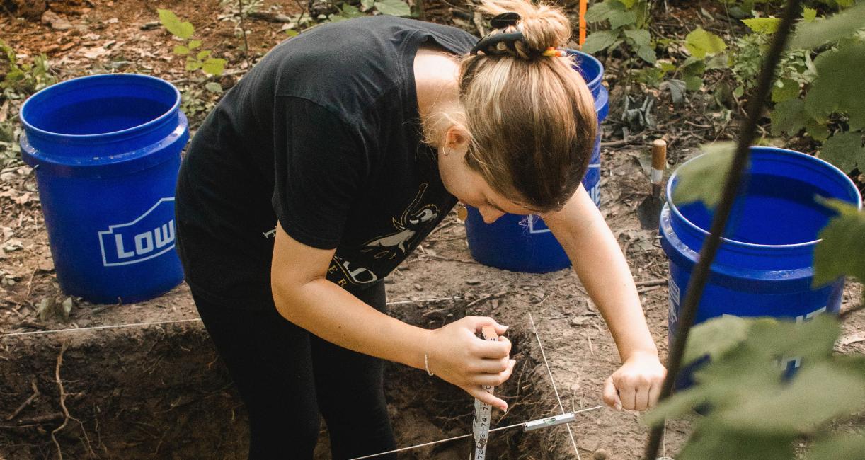 Student excavating dig site during Field School