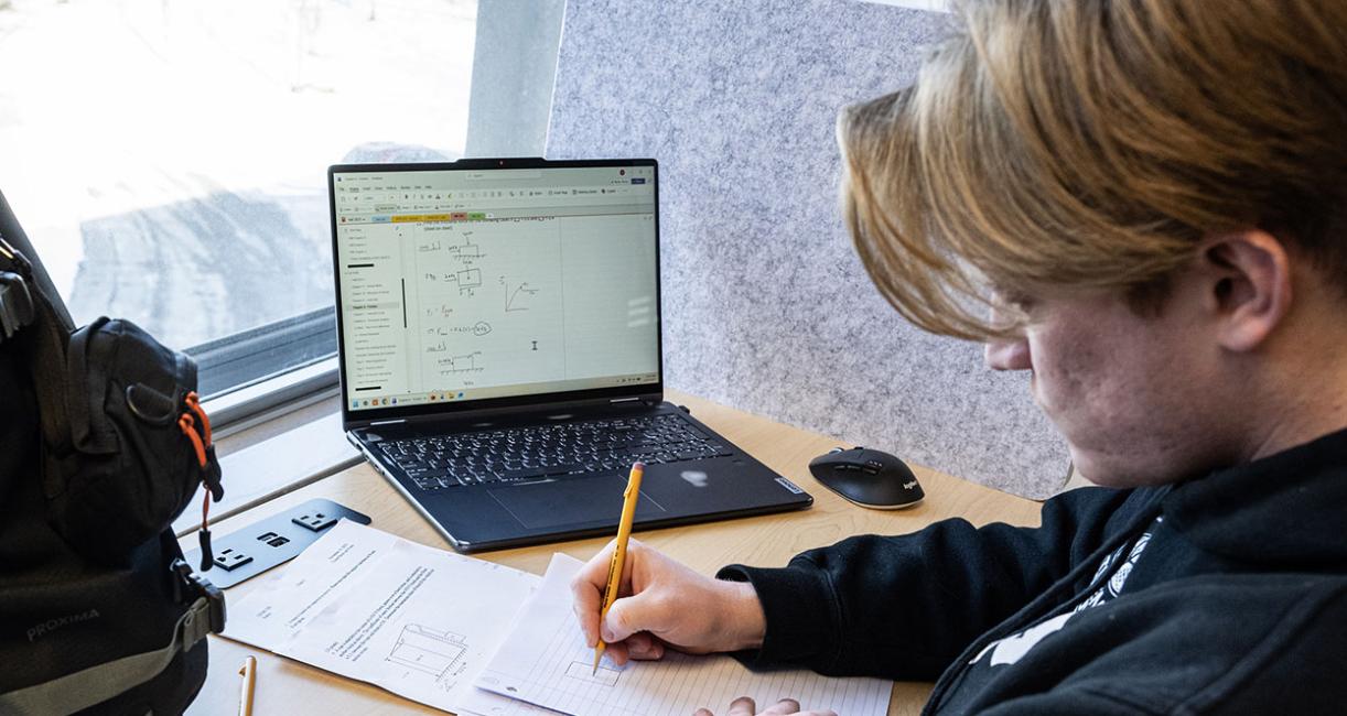 A student is doing homework near a window