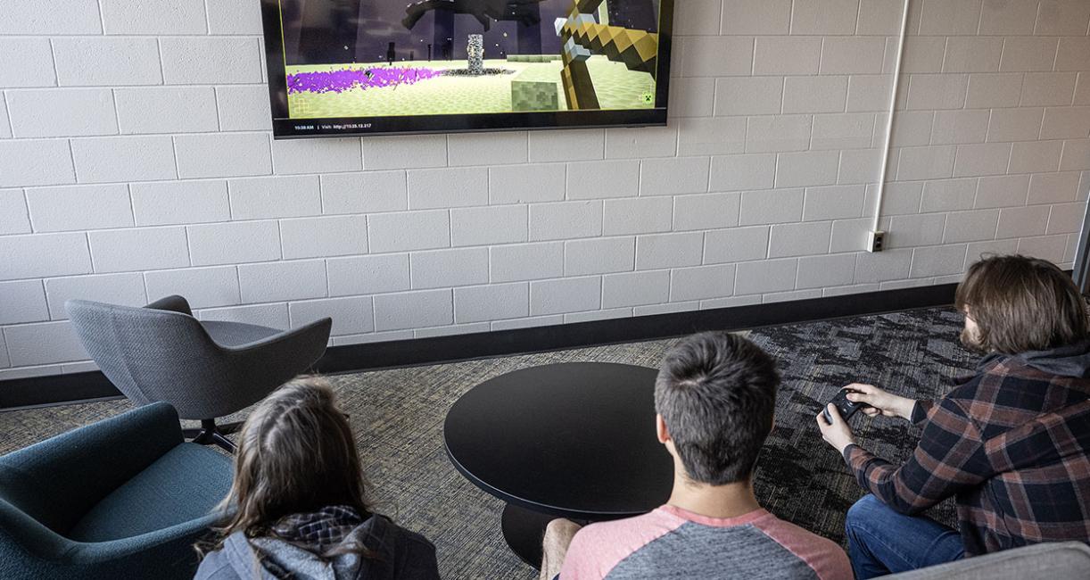 Three students are playing Minecraft