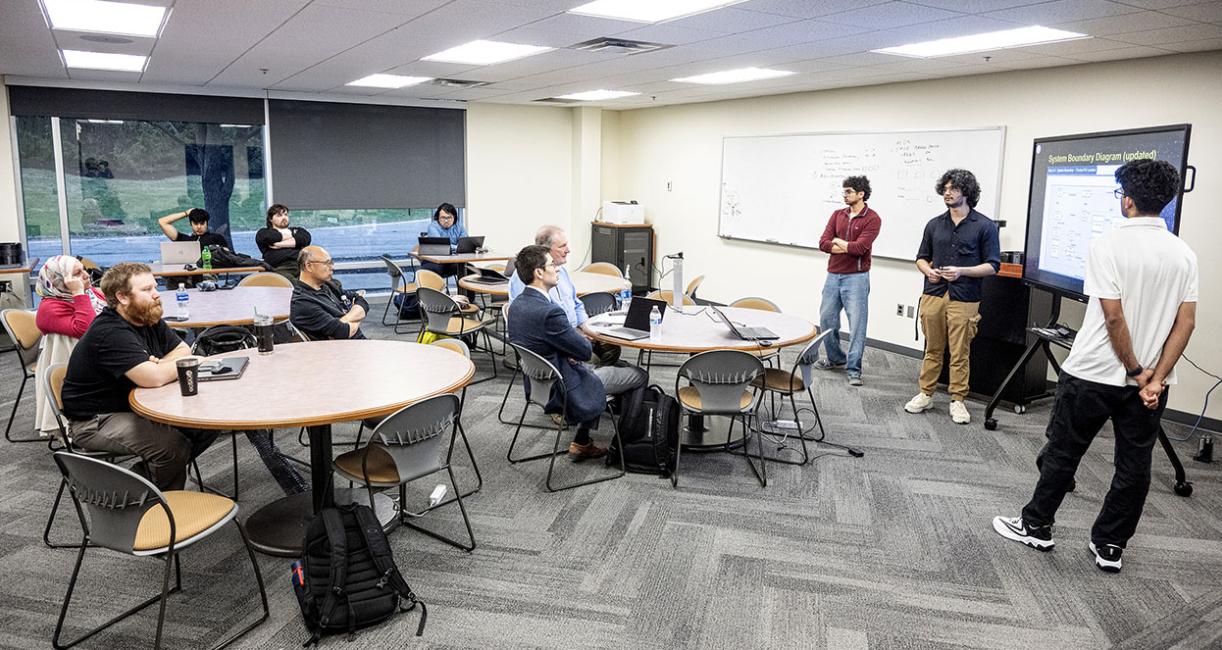 Members of the Lunabotics team and faculty are in a classroom