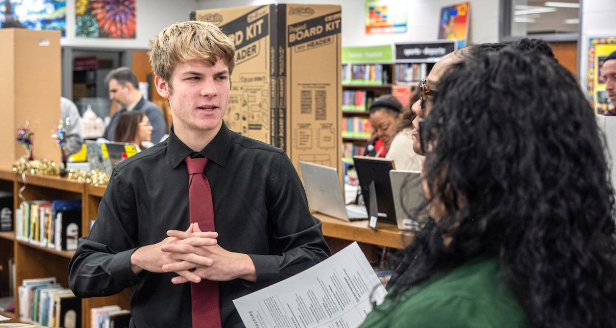 Two students are conversing at the SOE Showcase