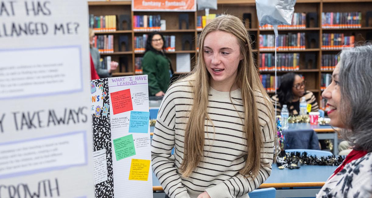 A student is sharing her presentation with Isabel Nunez