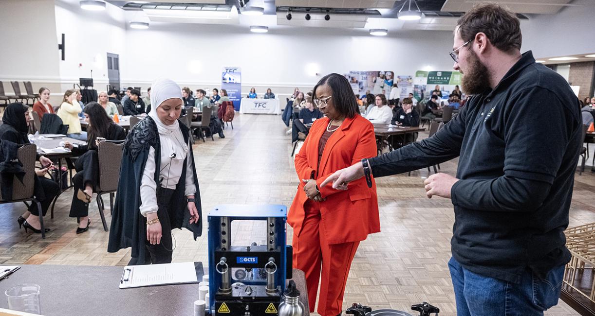 Mayor Sharon Tucker is talking to attendees at a conference