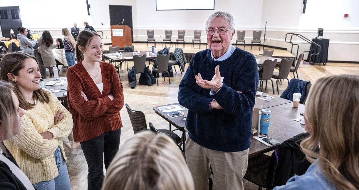 Attendees at a conference are speaking to each other
